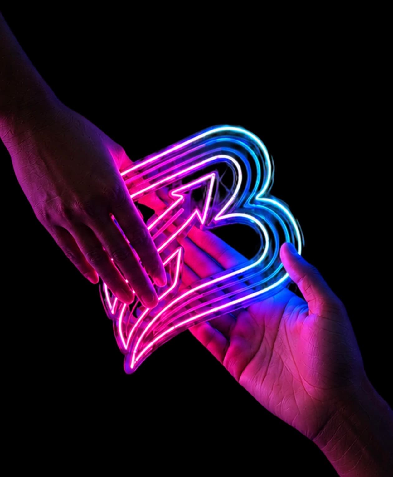 Official Brandiplex neon logo held between two hands